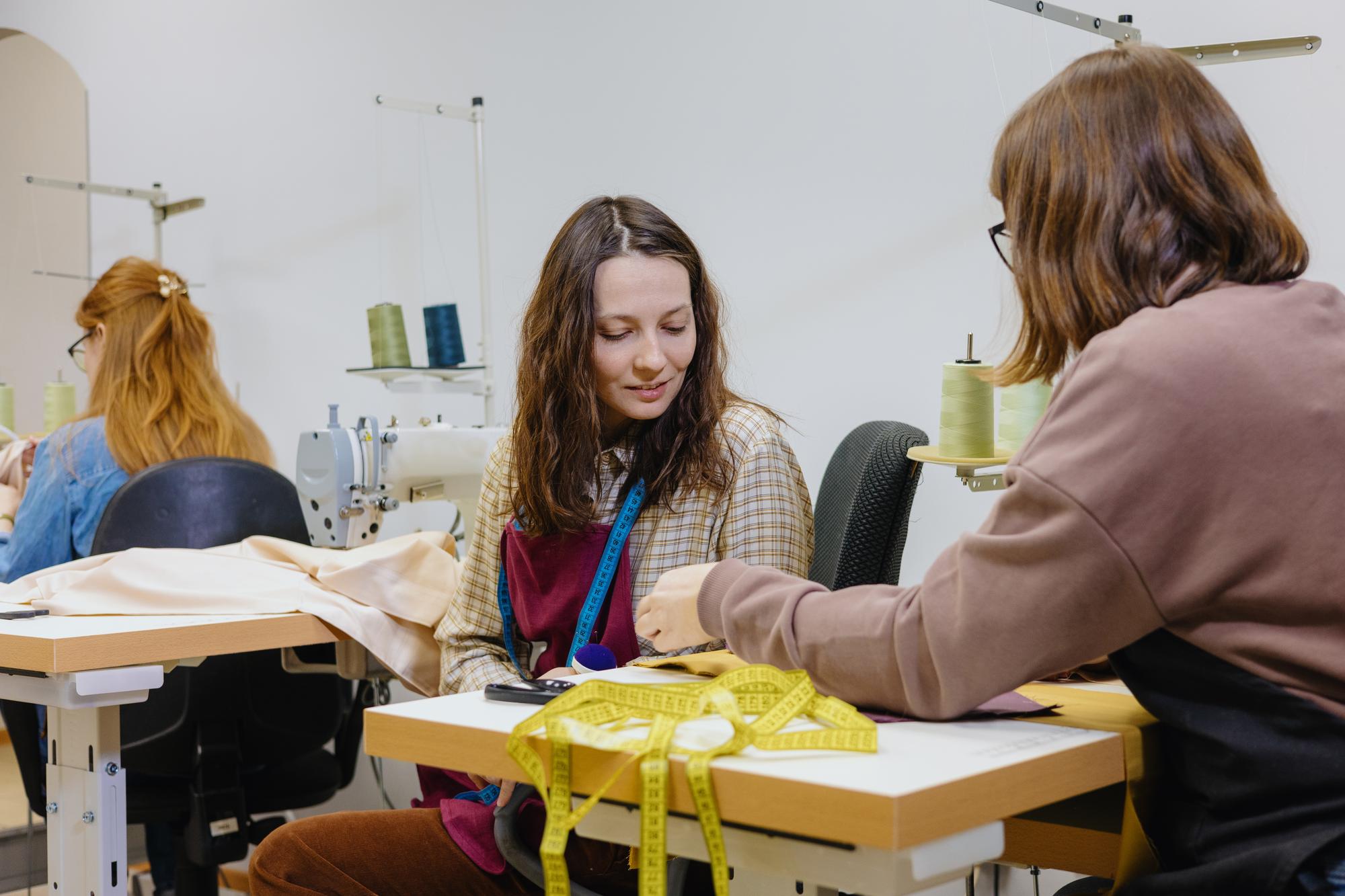 Instructor demonstrating satin stitch to a small group